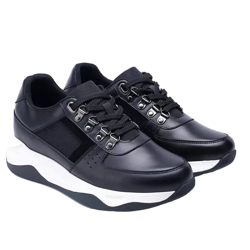 Black sneakers with white soles on a light gray background